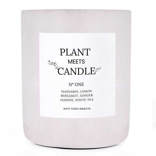 A light grey concrete candle vessel labelled as Plant Meets Candle No. One.